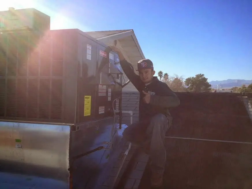 HVAC technician performing Boiler Repair on a rooftop unit in Oldsmar